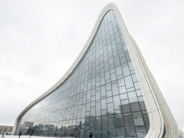 The snow-covered surroundings of the Heydar Aliyev Center accentuate the building's striking modern architecture in Baku, Azerbaijan