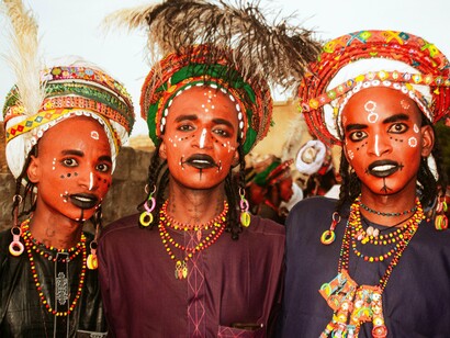 Wodaabe men in ceremonial attire celebrate their heritage, embodying the spirit of reclaiming Africa’s cultural identity from colonial erasure