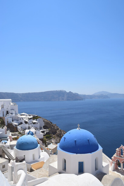 Captivating daytime scenes: blue dome buildings in Santorini, Greece