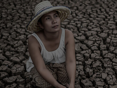 Seated amidst the dry landscape affected by global warming, the woman looking skyward, her silent plea for rain echoing in the air, as she yearned to relieve the earth from its relentless aridity