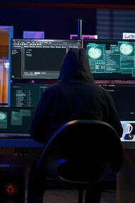The common sense image of a hacker, someone who could cyberattack a corporation