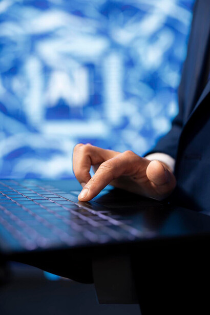 Person working on a computer in a dimly lit room