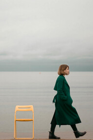 A person walking alone along the seashore