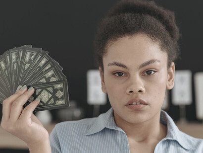 As she lays out her cards, the imagery of rebirth speaks to the evolution of financial systems, reminding us that destruction often precedes renewal