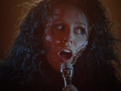 A still of Miley Cyrus from the Something Beautiful video captures the emotional depth and visual elegance of the track