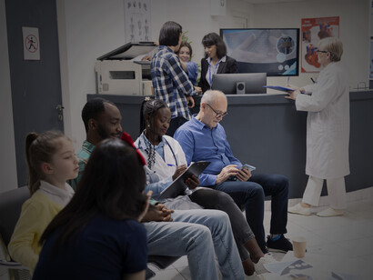 A busy medical clinic lobby with a reception counter, where diverse patients wait to be seen for routine visits or emergency examinations