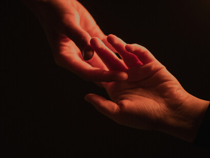 Hands touch one another in a playful manner