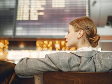 Stylish young woman sitting alone in an airport waiting area