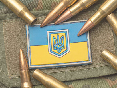 Ukrainian flag, bullets, and camouflage, resilience personified