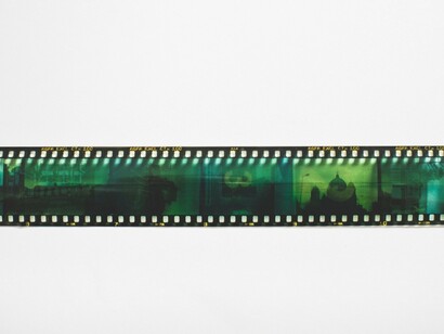 A preserved strip of photographic film awaiting its next viewing, representing the fragile state of Argentina's cinematic heritage