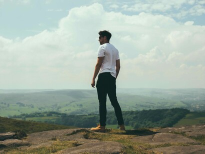 A man hiked up a hill searching for the answers that not only plague his mind by tear up his soul