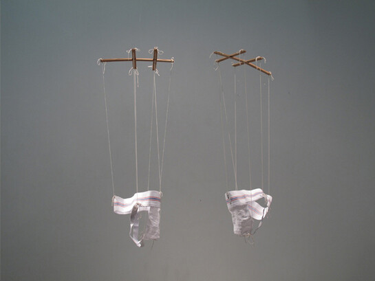 Anna Campbell, Coquettes (s,l), 2013, two jockstraps sized small and large, wood, twine, 1 x 1 x 3 in each