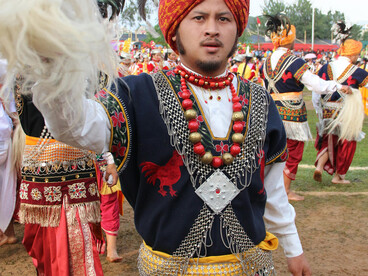 Members of the Khasi tribe dressed in traditional clothing performing in a cultural parade in Meghalaya, India