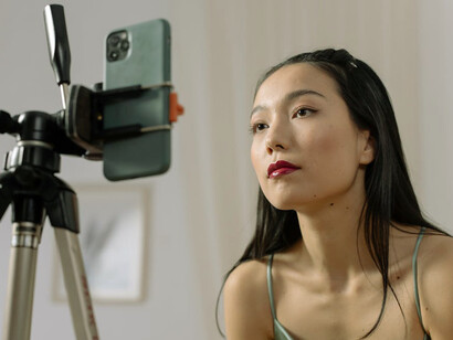 With her phone in hand, she works on producing content that reflects the entrepreneurial spirit and innovative strategies of the modern world