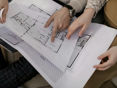 A group of people looking at the plans for a building, embodying the thoughtful planning behind liminal landscapes