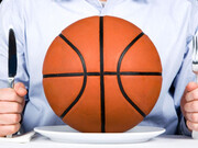 A man with a knife and fork, and a basketball