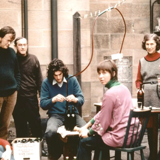 NSW Government Astronomer and Director of Sydney Observatory Harley Wood bottling wine in the Observatory courtyard with family and friends, 1972. Courtesy of Powerhouse