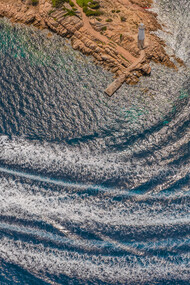 Luxury boats line the crystal-clear shores of Sardinia, Italy