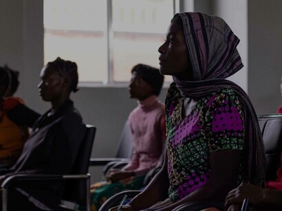 An African Muslim woman is in the waiting room to receive her immigration documents