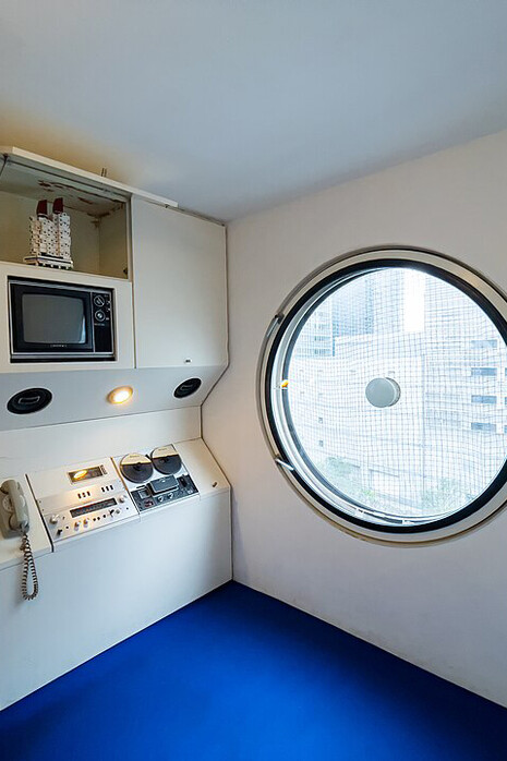 A Nakagin Capsule Tower capsule on display near Roppongi Hills Mori Tower in Tokyo, Japan, highlighting its small scale living space
