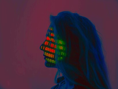 A woman sorting out her AI conundrum while having a binary code on her face