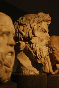 A photo of four philosophical busts, featuring Aristotle and other great thinkers, capturing the essence of timeless wisdom