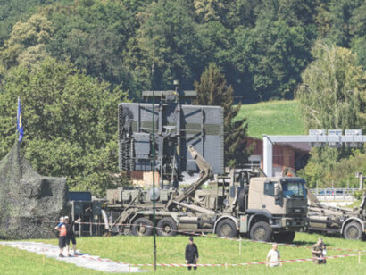 Mobile radar system on a hill at Swiss military training ground on a hot summer day near Swiss airport