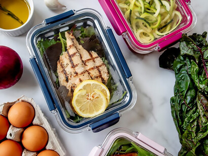 A white plastic container adorned with precisely sliced lemons not only embodies the spirit of healthy eating and food preparation 