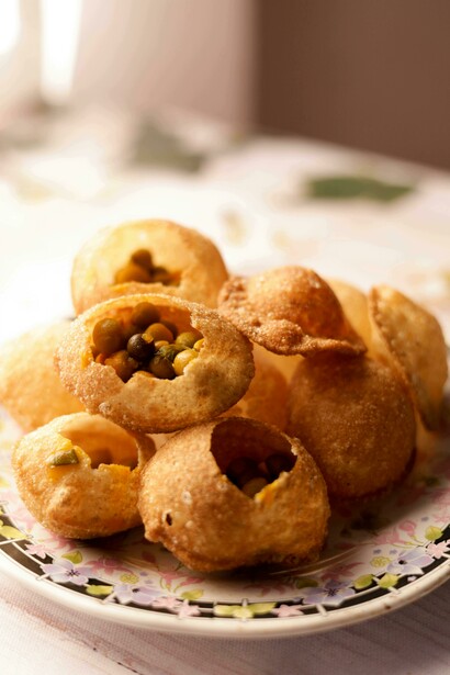 Gol Gappa, the iconic Indian street snack, beautifully served on a ceramic plate in a fine dining style of pani puri