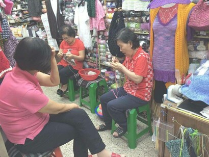 Korean women sewing in a marketplace