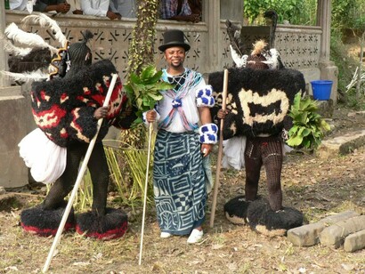 Chief Ekpenyong Bassey Nsa, Two raffia Efik Ekpe masquerades with Chief Ekpenyong Bassey Nsa during his Ekpe chieftaincy installation, Creek Town, Nigeria, December 31, 2009. Courtesy of NOMA