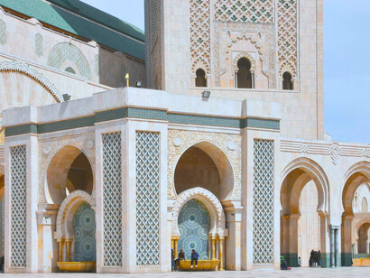 Intricate Moroccan arches and geometric detailing at the Hassan II Mosque, representing the Kingdom’s lasting spiritual and architectural heritage