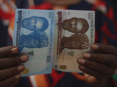 An image of a confident woman holding a stack of African currency notes symbolizes business success, wealth, and Africa's abundant resources