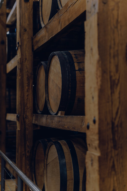 Within the winery's cool and cavernous cellar, the barrels patiently age, allowing the wine to develop its distinct flavors and characteristics