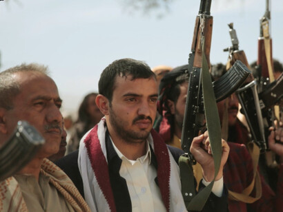 Cheering Houthis in Yemen demonstrate their unity and resolve, reflecting the broader threat posed by extremist coalitions to regional peace and international shipping routes
