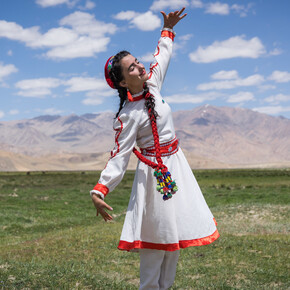 A girl in traditional Tajik dress dances at the opening of a new tourism centre in Bulunkul, a remote area in the Pamir mountains of Tajikistan.. Photo Credit Christopher Wilton-Steer and AKDN