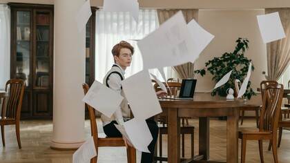 An professional surrounded by floating papers, showing how excessive planning can hinder meaningful progress