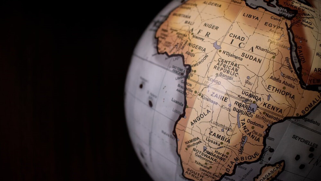 A desk globe featuring both white and brown colors, with Africa prominently displayed on the globe