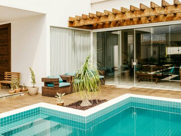 A poolside lounge flowing seamlessly into interior spaces, reflecting the growing importance of transitional architecture