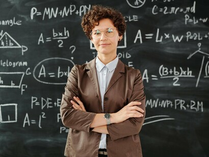 Professora em frente à lousa. O fato é que a presença e a circulação de materiais à disposição de professores e alunos (aqui me refiro aos documentos oficiais PCNs, BNCC, livros distribuídos pelo Governo), não indica de modo algum o que os usuários fazem com eles (suas artes de fazer), pois se debruçam com materiais que não fabricam, vale dizer, atuam no espaço do outro