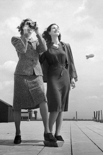 Two models on a rooftop in Bloomsbury, London, wearing wartime fashions in 1943