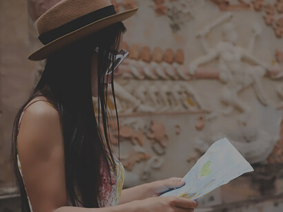 An old town, a girl eagerly navigates with a tourist map, immersing herself in cultural experiences and exploring enticing travel destinations