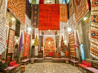 Colourful Moroccan carpets in Fez, Morocco, symbolising the fusion of craft and history