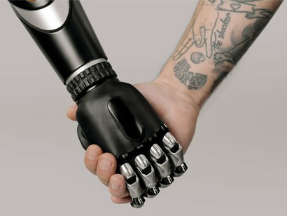 Human and robot holding hands, symbolising the future of human-AI collaboration in the workplace