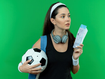 A folding holding a soccer ball and tickets highlight the financial role of ticket sales in sports economy