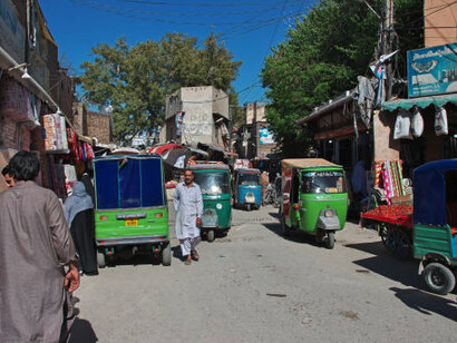 A lively bazaar in Peshawar, Pakistan, filled with colorful stalls and local vendors