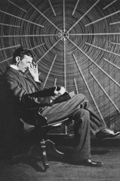 Nikola Tesla, with Roger Boskovich's book, “Theoria Philosophiae Naturalis,” in front of the spiral coil of his high-frequency transformer at East Houston St. 46, New York, United States