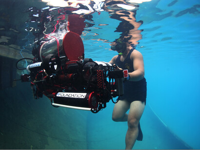 A diver recovering an automatic underwater vehicle as part of an operation aimed at elevating resource exploitation to new levels