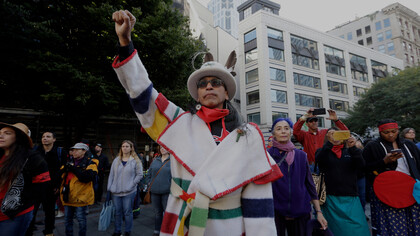 Art Cedar, of the Aluet and Blackfeet tribes, raises a fist at an Indigenous Peoples Day event in Seattle