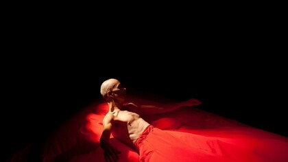 Un hombre levantándose de un camastro